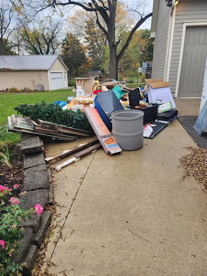 Dumpster being loaded with debris for Estate Cleanout Dumpster Rental in Southington